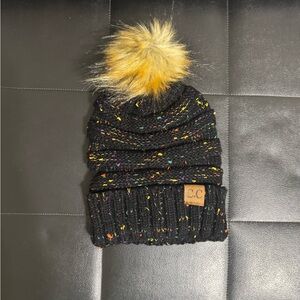 Ladies C.C Black Knit Beanie splashes of mixed color throughout with Pom cozier